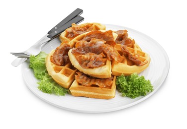 Photo of Plate with tasty Belgian waffles, bacon, lettuce and cutlery isolated on white