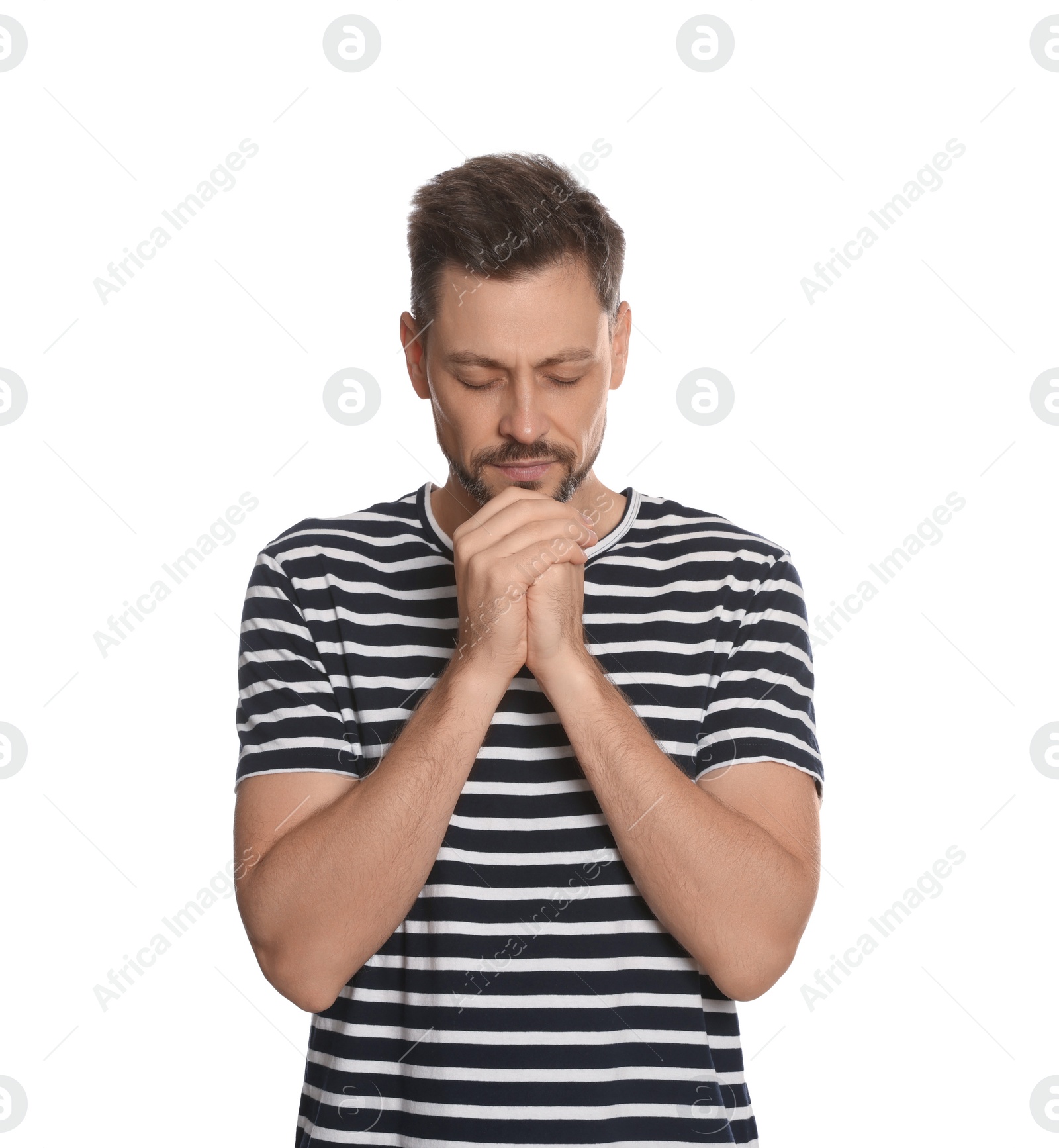 Photo of Man with clasped hands praying on white background