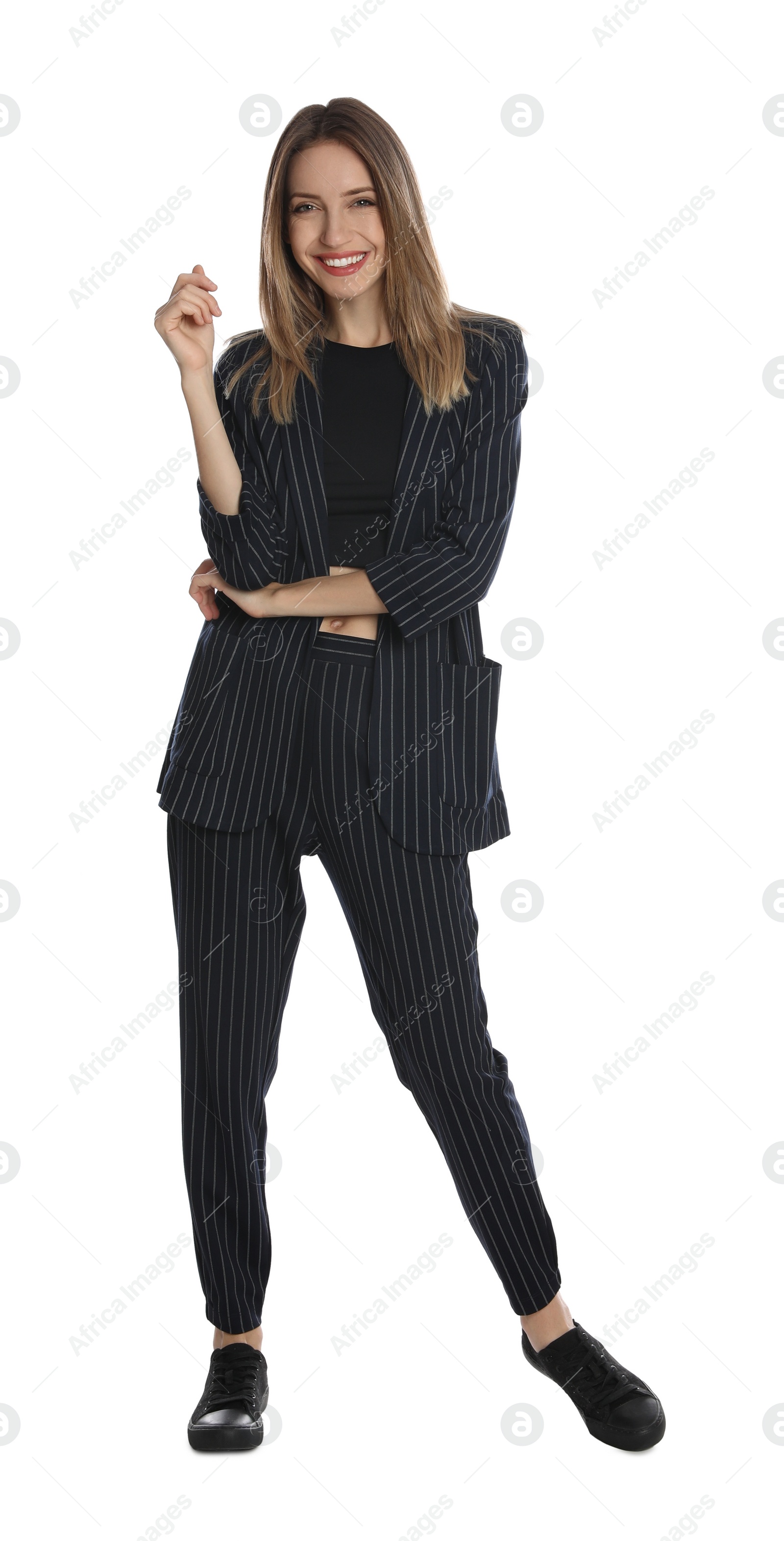 Photo of Full length portrait of beautiful young woman in fashionable suit on white background. Business attire