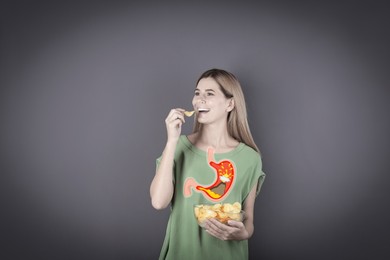 Improper nutrition can lead to heartburn or other gastrointestinal problems. Woman eating potato chips on dark grey background. Illustration of stomach with erupting volcano as acid indigestion