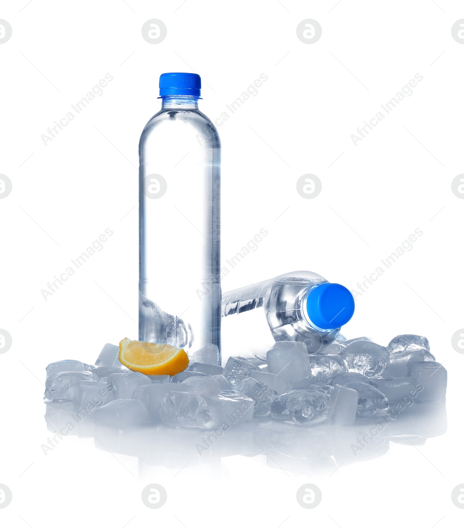 Photo of Bottles of water, lemon slice and ice cubes on white background