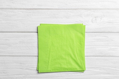 Photo of Clean napkins on wooden background, top view. Personal hygiene