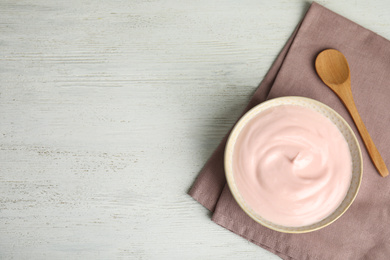 Photo of Tasty organic yogurt on white wooden table, top view. Space for text