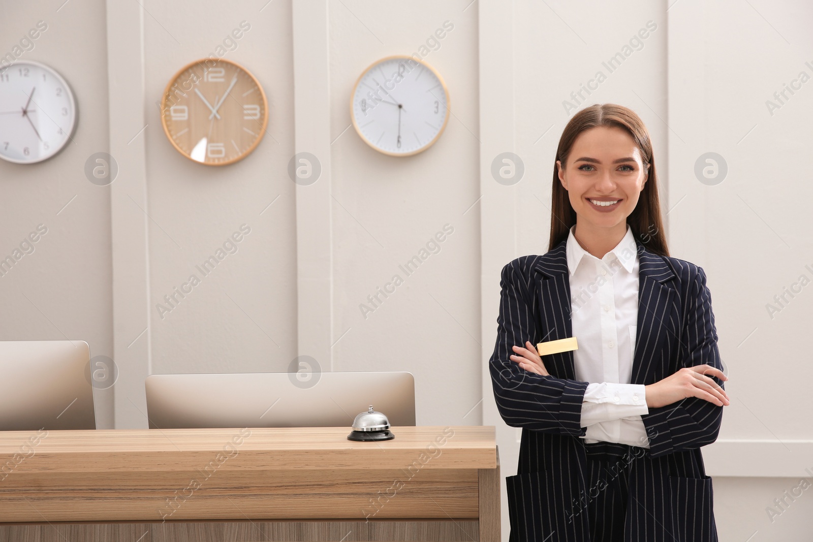 Photo of Portrait of beautiful receptionist near counter in hotel