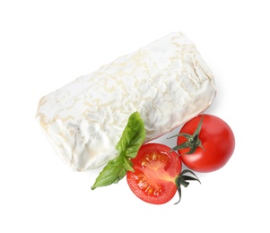 Delicious fresh goat cheese with basil and cherry tomatoes on white background, top view