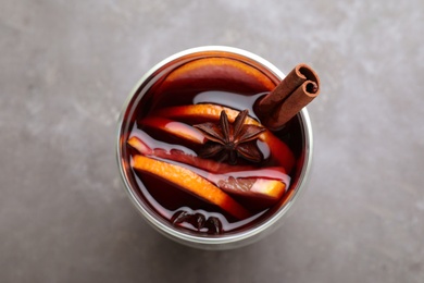 Photo of Aromatic mulled wine on grey table, top view
