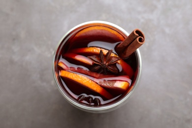 Aromatic mulled wine on grey table, top view