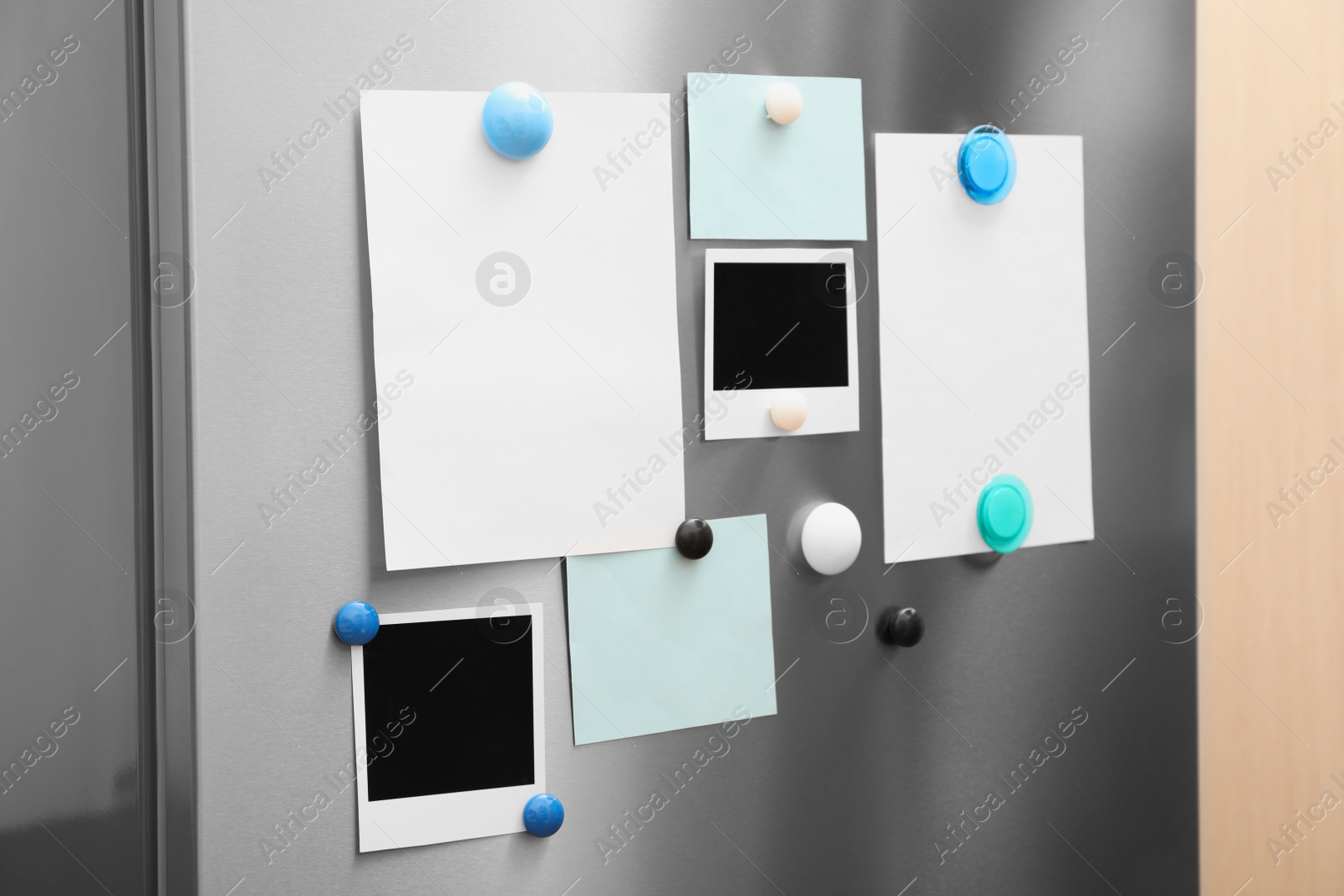 Photo of Sheets of paper and photos with magnets on refrigerator door indoors. Space for text