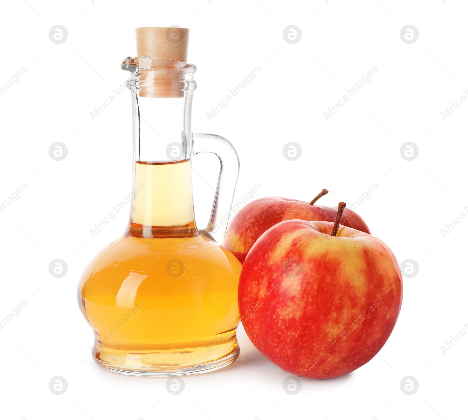 Photo of Glass jug of vinegar and fresh apples on white background