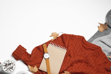 Flat lay composition with soft knitted sweater on white background