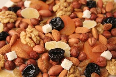 Different tasty nuts and dried fruits, closeup