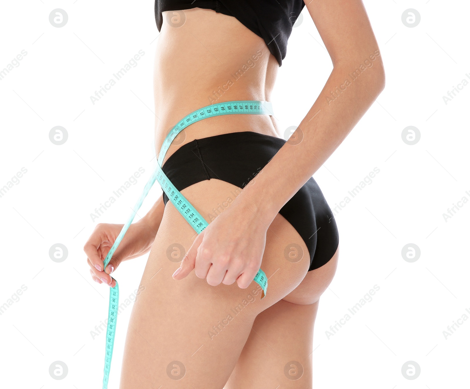 Photo of Slim woman measuring her waist on white background, closeup. Weight loss