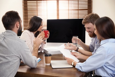 Photo of Group of colleagues using video chat on computer in office. Space for text