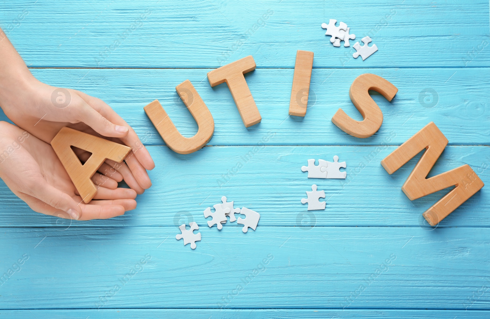 Photo of Woman and word AUTISM made with letters on wooden background