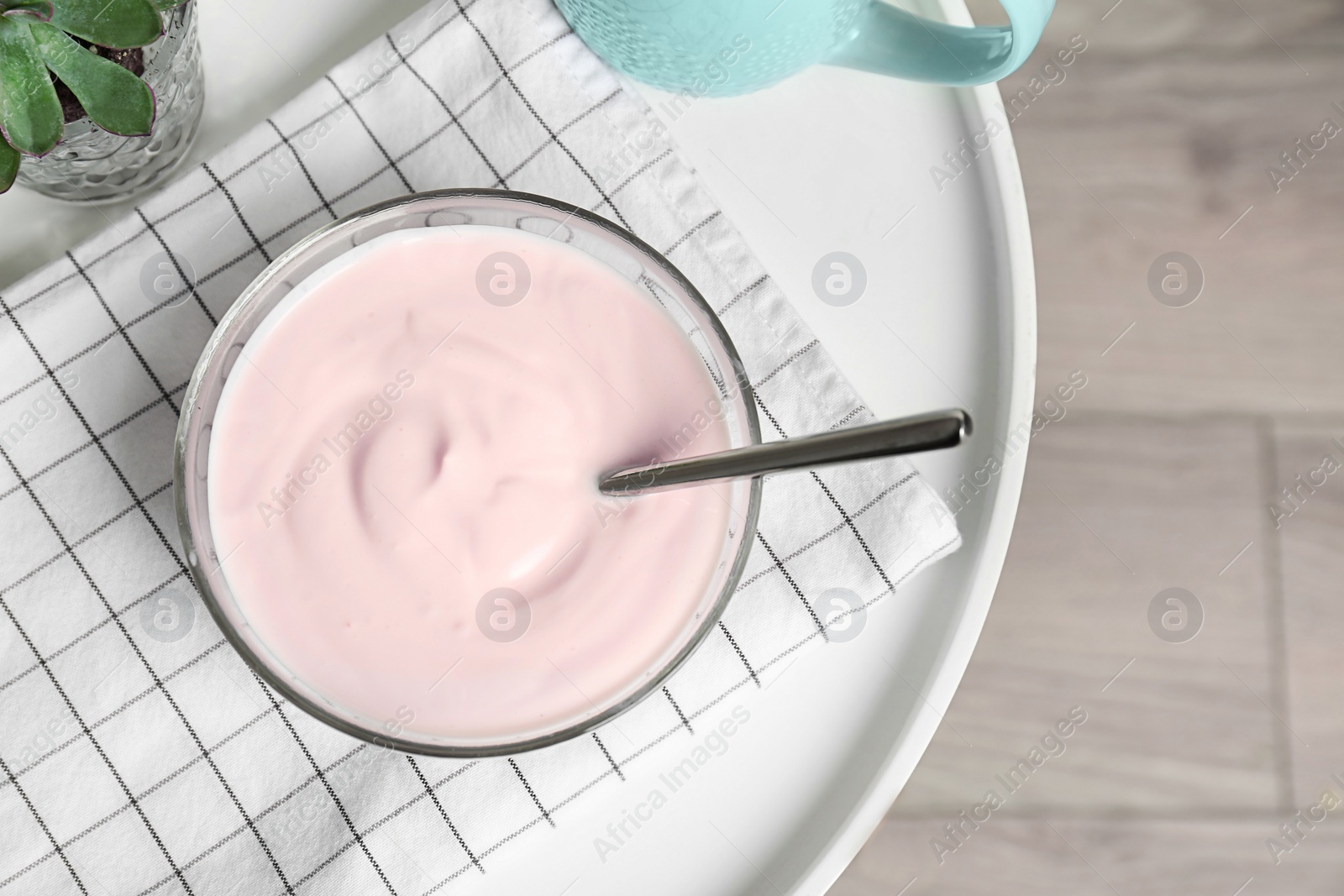 Photo of Bowl with yummy yogurt on table