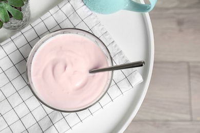 Bowl with yummy yogurt on table