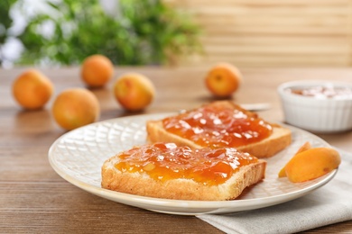 Photo of Bread with tasty apricot jam on plate