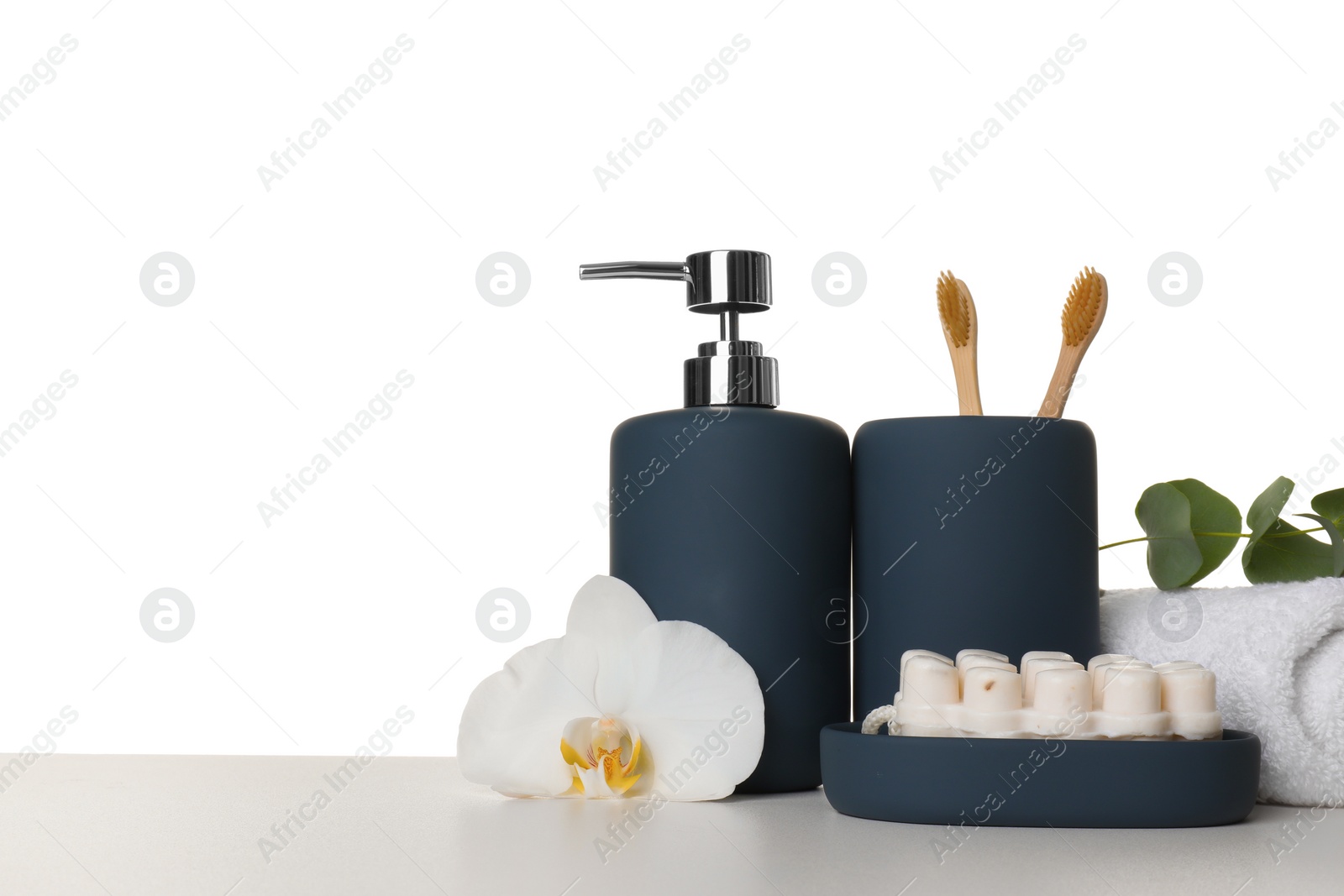 Photo of Bath accessories. Different personal care products, flower and eucalyptus branch on table against white background. Space for text