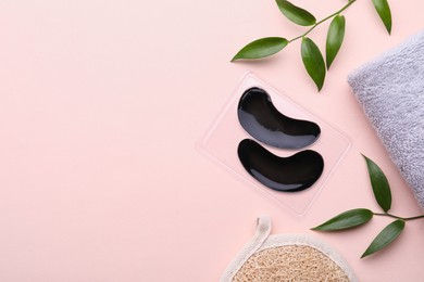 Photo of Flat lay composition with under eye patches on light pink background. Space for text