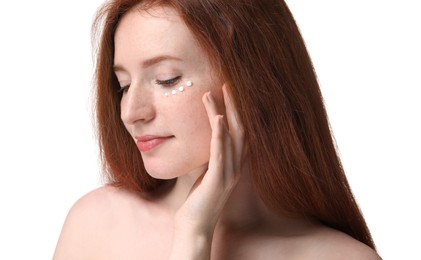 Beautiful woman with freckles and cream on her face against white background