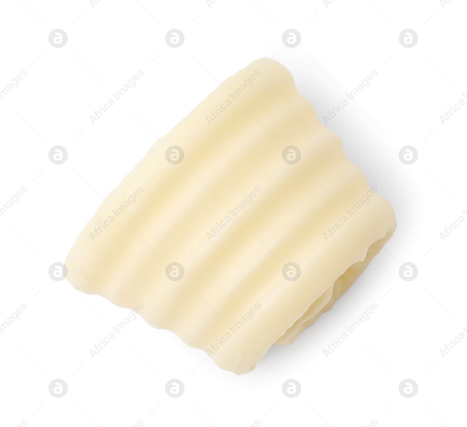 Photo of One tasty butter curl isolated on white, top view