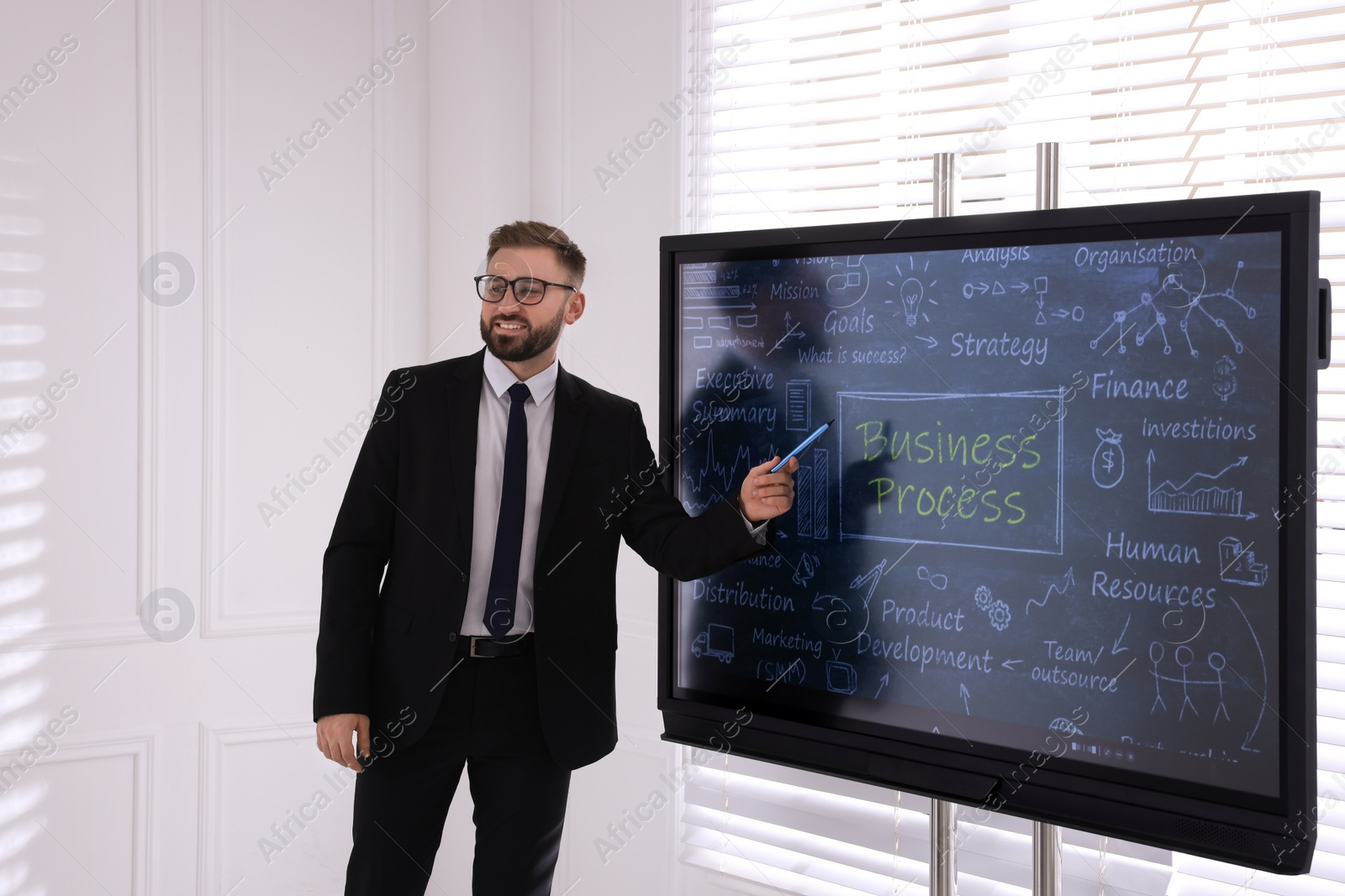 Photo of Business trainer using interactive board in meeting room during presentation