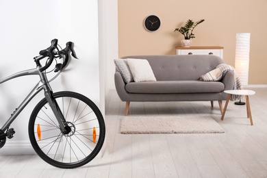 Modern apartment interior with bicycle near wall