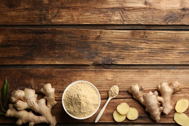 Photo of Dry ginger powder and fresh root on wooden table, flat lay. Space for text