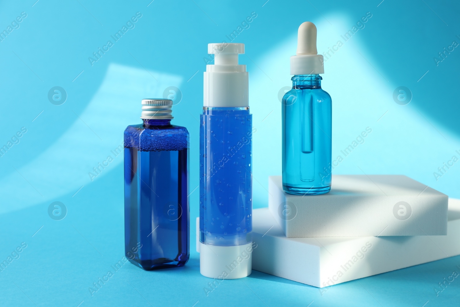 Photo of Set of luxury cosmetic products on light blue background