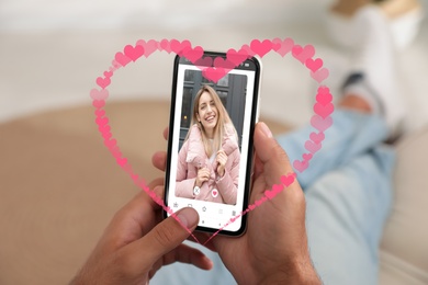 Man visiting dating site via smartphone indoors, closeup