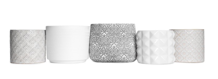 Photo of Different stylish ceramic flowerpots on white background