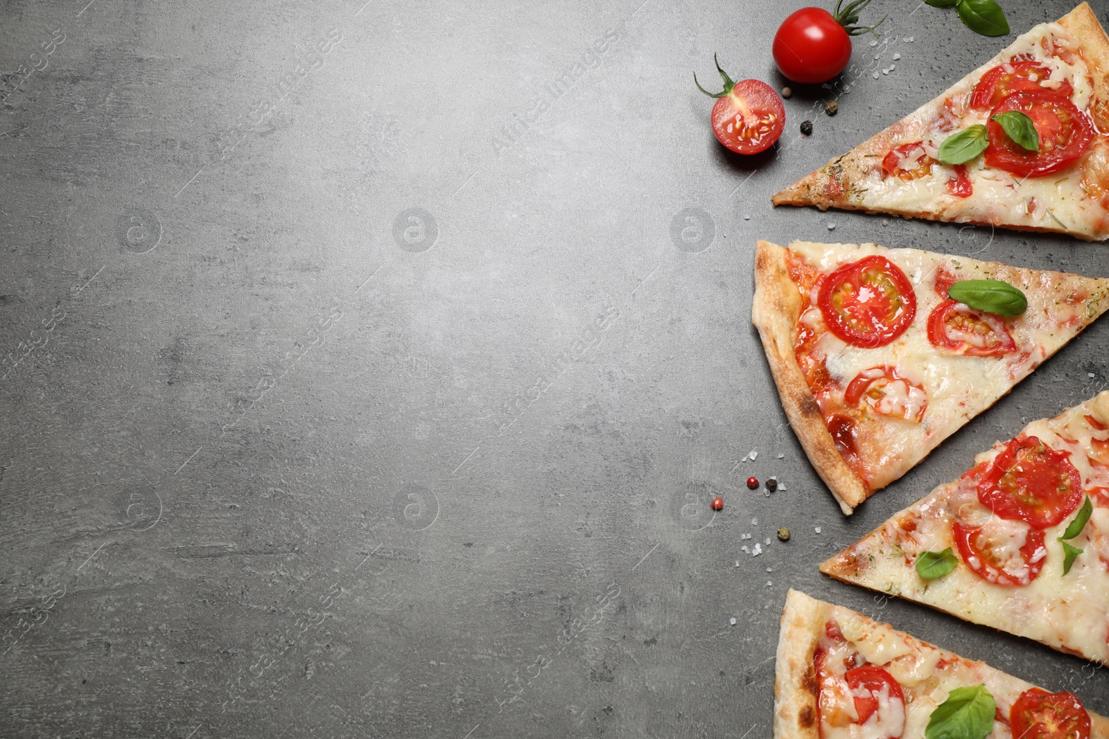 Photo of Slices of delicious pizza Margherita on grey table, flat lay. Space for text