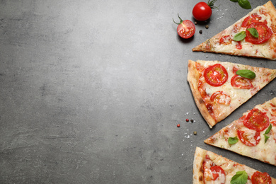 Photo of Slices of delicious pizza Margherita on grey table, flat lay. Space for text