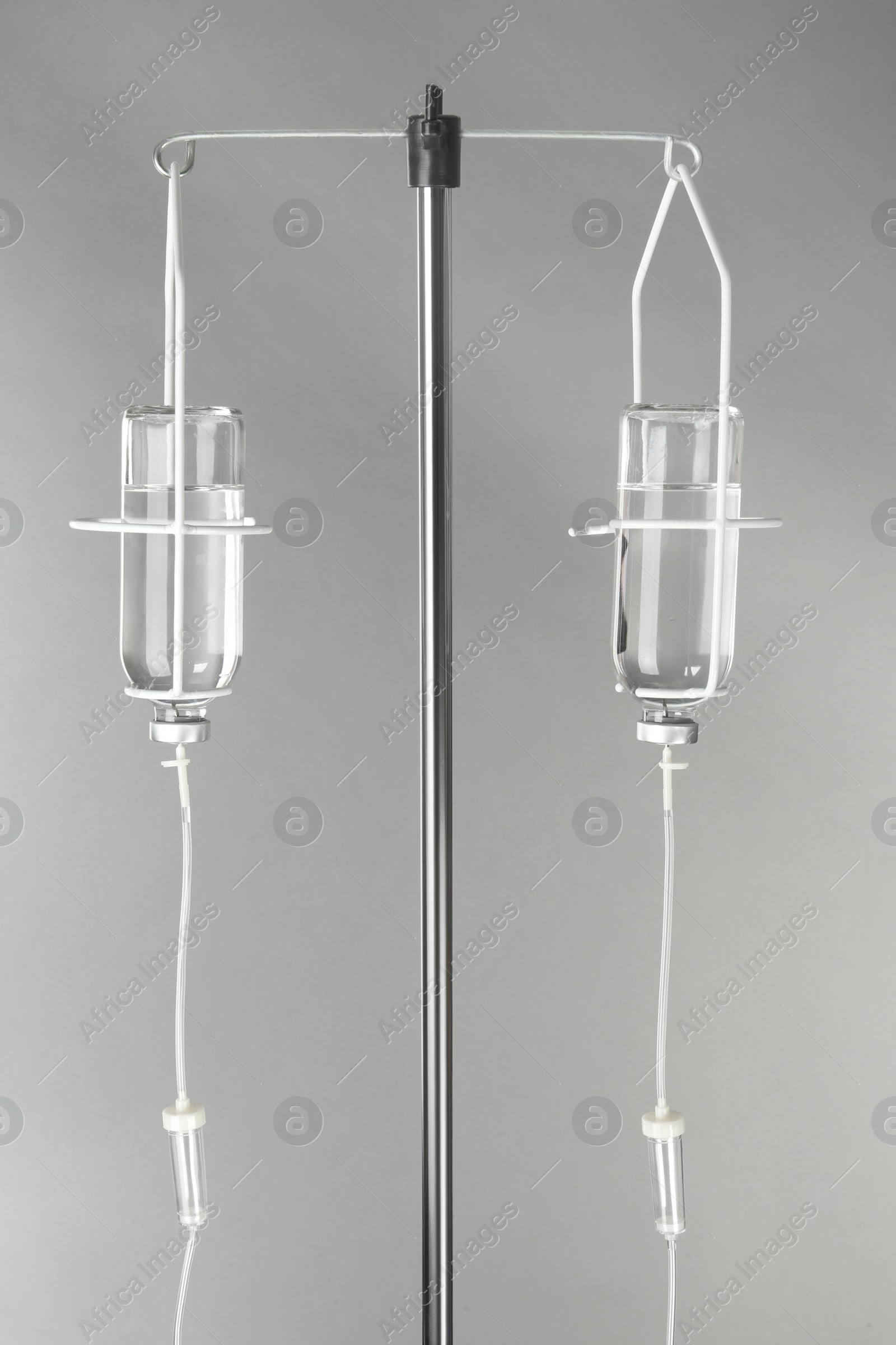 Photo of Drop counter with bottles of medicine on grey background