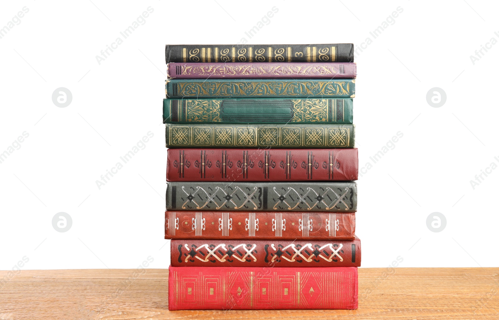 Photo of Stack of old vintage books on wooden table against white background