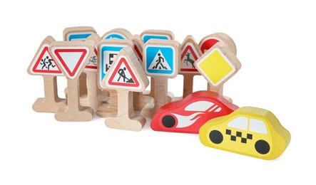 Photo of Set of wooden road signs and cars isolated on white. Children's toy