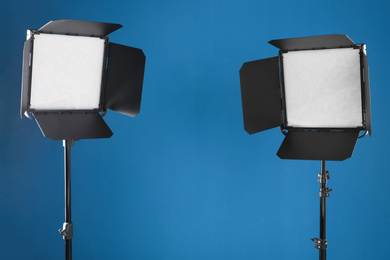 Photo of Professional lighting equipment for video production on blue background