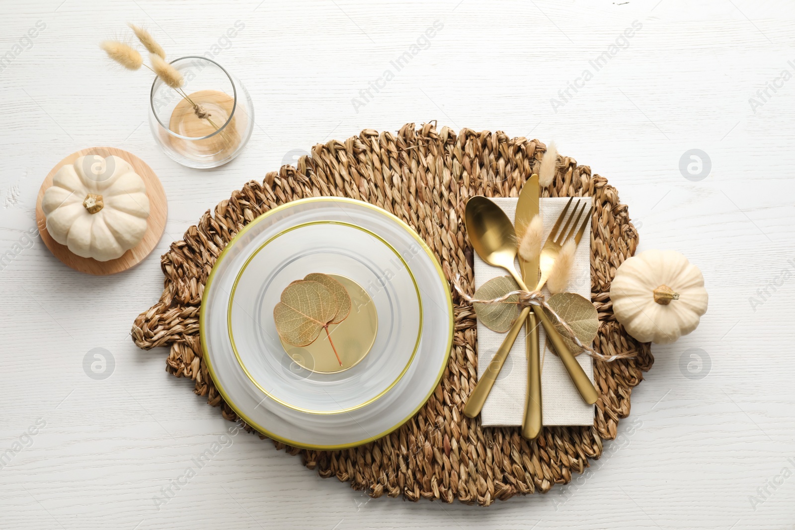 Photo of Autumn table setting with pumpkins on white wooden background, flat lay