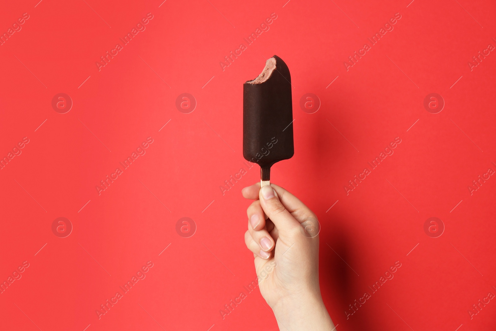 Photo of Woman holding delicious ice cream with chocolate against color background, space for text