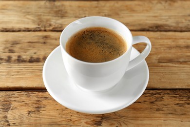 Cup of tasty coffee on wooden table