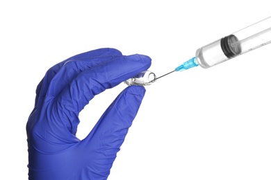 Doctor in medical glove with syringe and ampule on white background