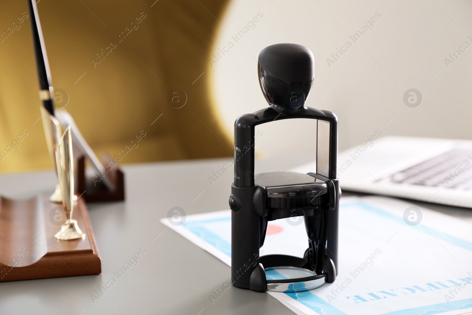 Photo of Automatic stamp and documents on desk in notary's office