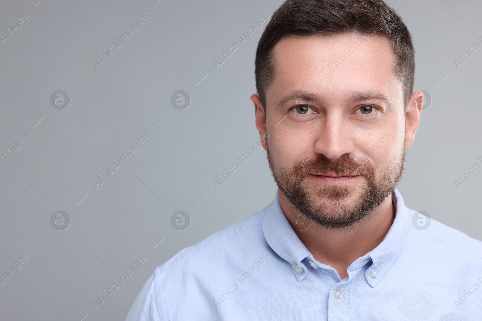 Photo of Portrait of man on grey background, space for text