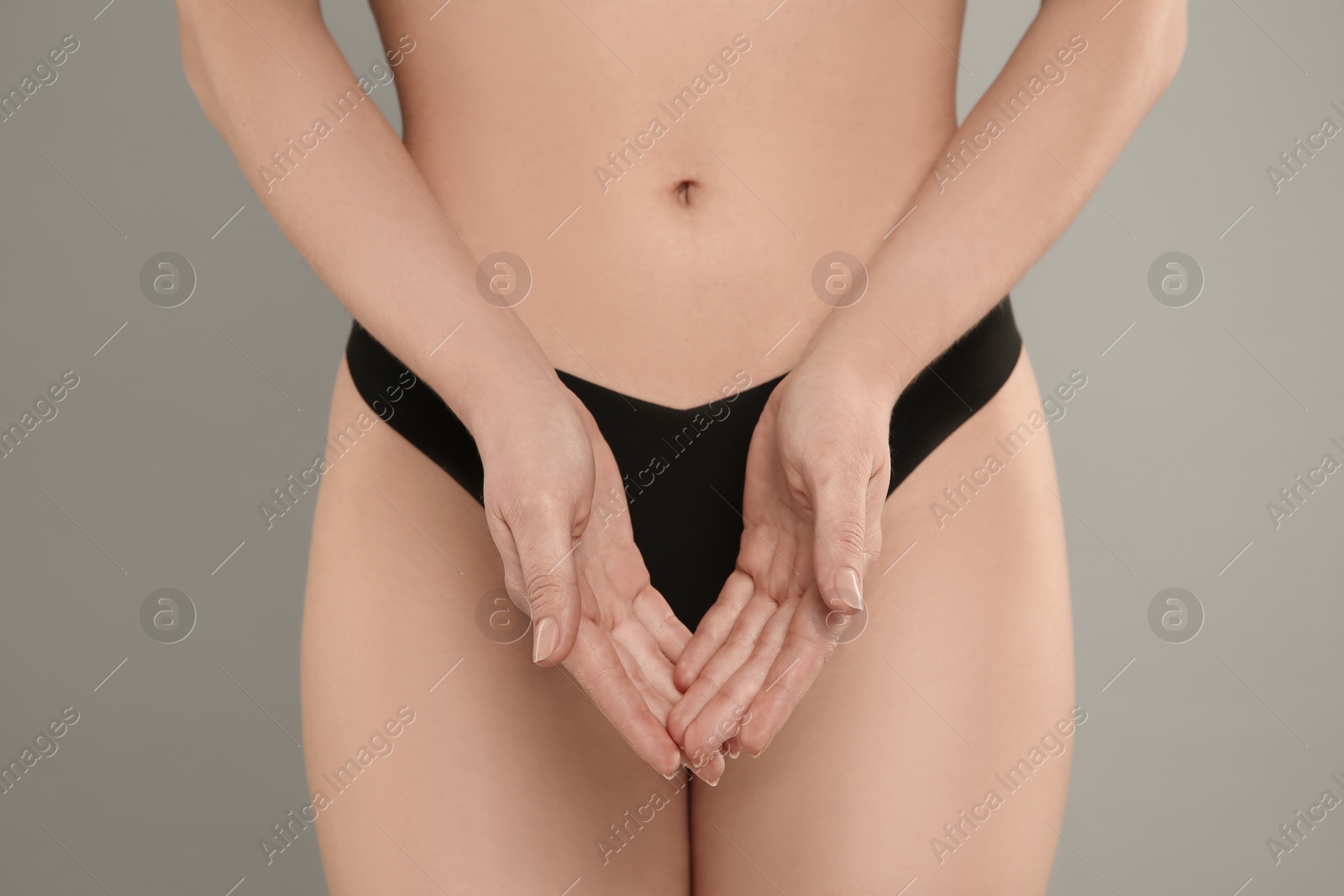 Photo of Gynecology. Woman in underwear on grey background, closeup