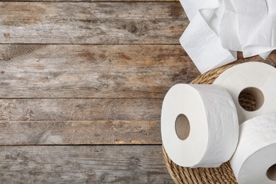 Photo of Toilet paper rolls on wooden background, top view. Space for text