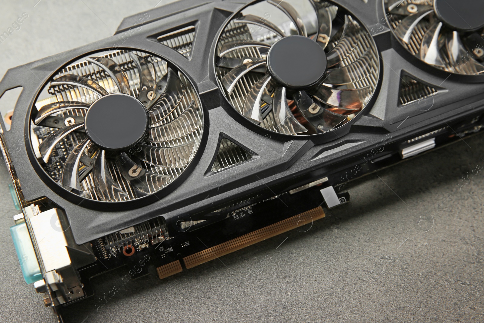 Photo of One computer graphics card on grey textured table, closeup