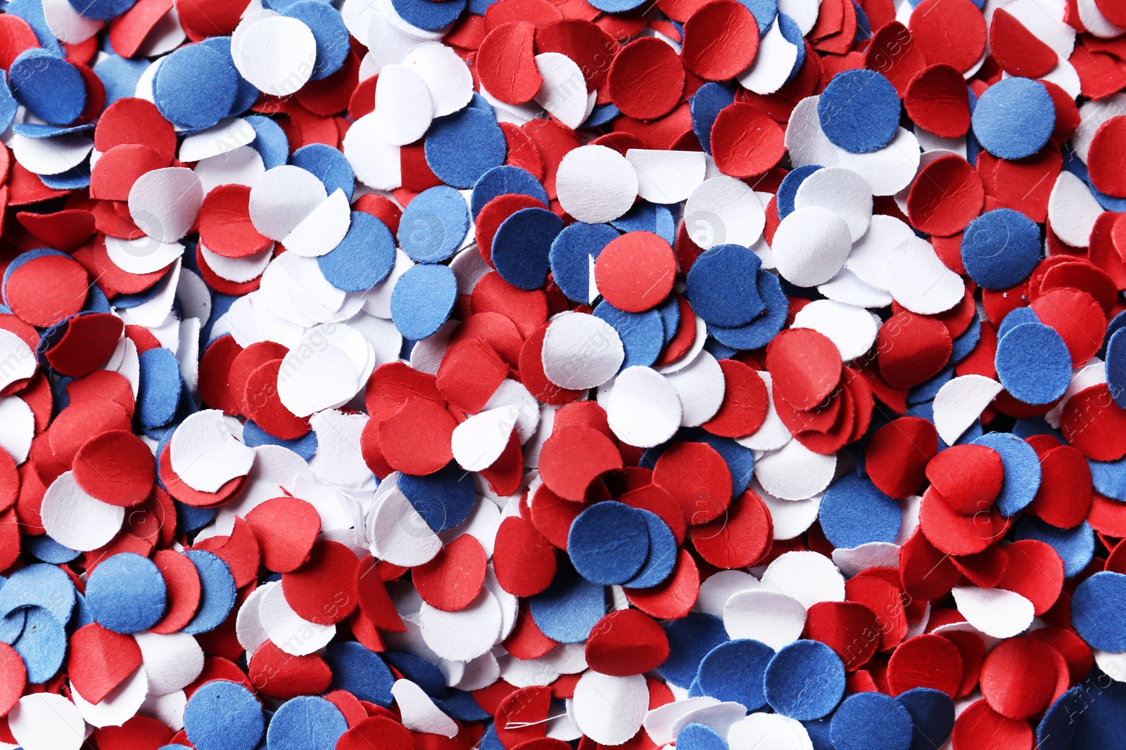 Photo of Many bright confetti as background, closeup. USA Independence Day