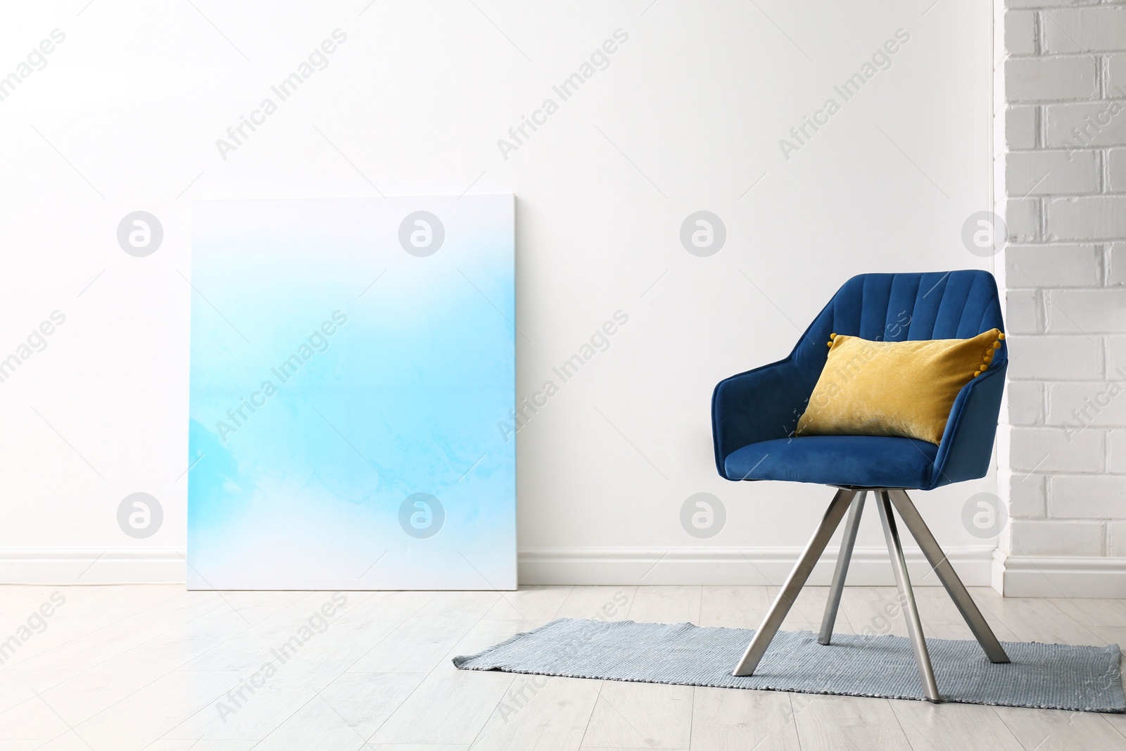 Photo of Comfortable armchair with cushion indoors. Space for text