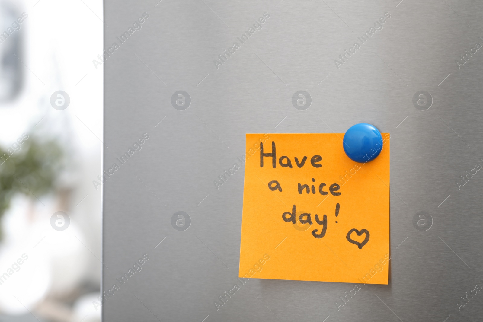 Photo of Note with text "Have a nice day" and magnet on refrigerator door in kitchen. Space for text