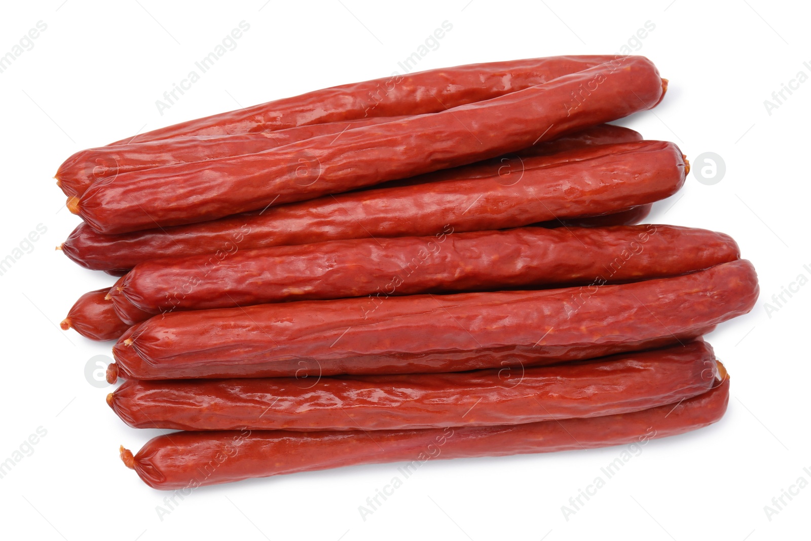 Photo of Delicious smoked sausages isolated on white, top view